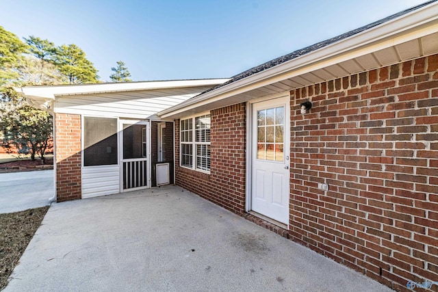 entrance to property featuring a patio