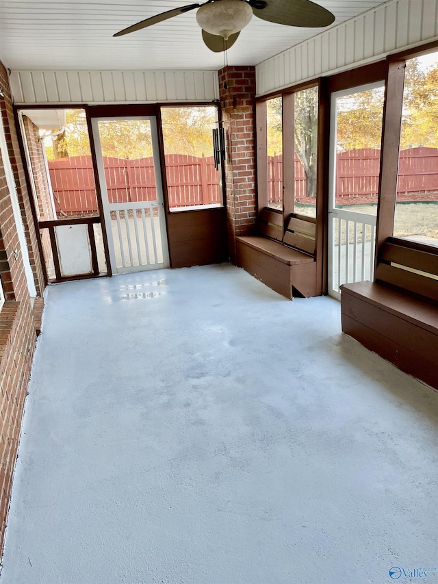 unfurnished sunroom with ceiling fan and a healthy amount of sunlight