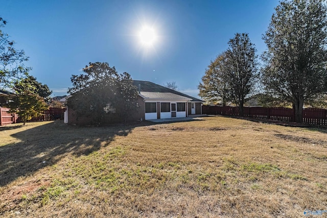 back of property featuring a lawn