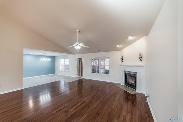 unfurnished living room with a fireplace, hardwood / wood-style floors, and lofted ceiling