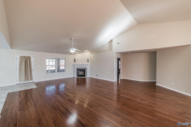 unfurnished living room with ceiling fan, lofted ceiling, and dark wood-type flooring