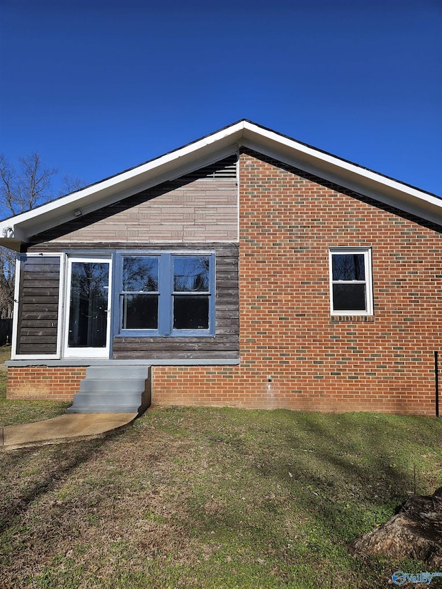 view of side of home featuring a lawn