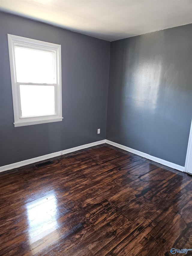 unfurnished room with dark hardwood / wood-style floors