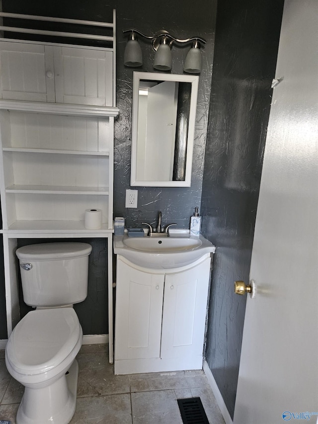 bathroom featuring vanity, tile patterned floors, and toilet