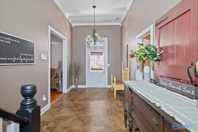 entryway featuring baseboards, ornamental molding, and a notable chandelier