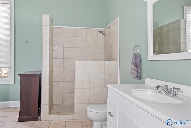 full bath with vanity, a tile shower, toilet, and tile patterned floors