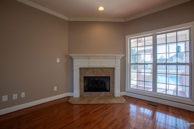 unfurnished living room with hardwood / wood-style flooring, a fireplace, and crown molding