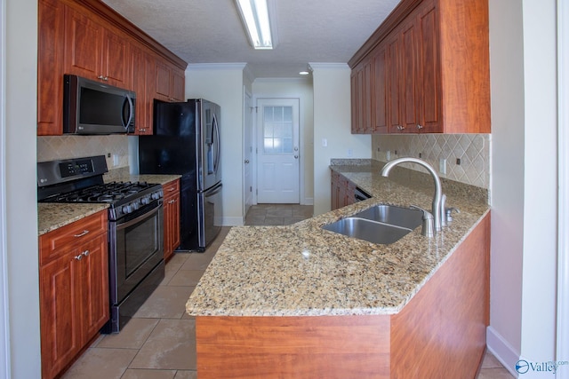 kitchen featuring sink, refrigerator with ice dispenser, kitchen peninsula, light stone countertops, and gas range oven