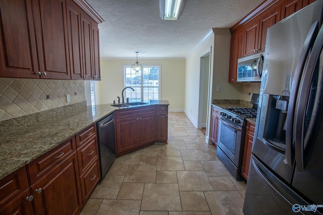 kitchen featuring appliances with stainless steel finishes, pendant lighting, sink, ornamental molding, and kitchen peninsula