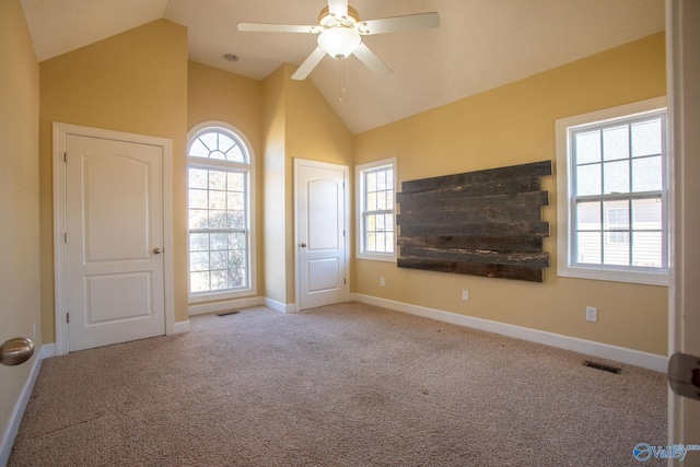 unfurnished living room featuring lofted ceiling, light colored carpet, and ceiling fan