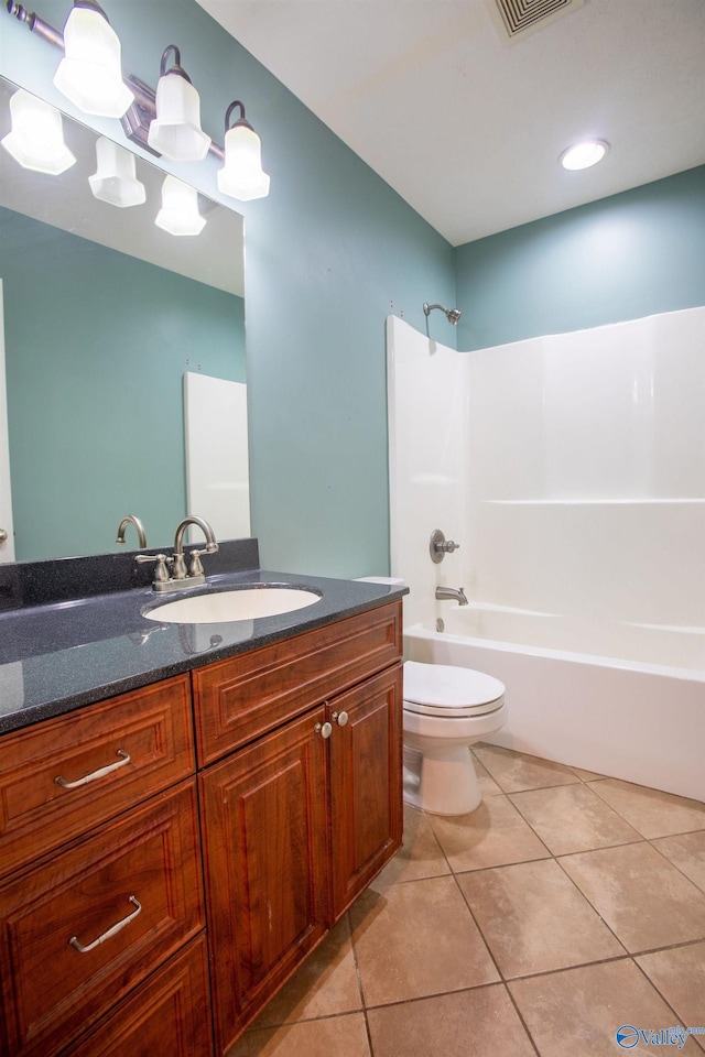 full bathroom with washtub / shower combination, tile patterned floors, toilet, and vanity