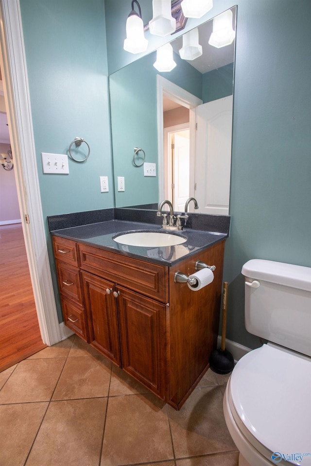 bathroom featuring tile patterned floors, toilet, and vanity