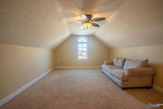 bonus room with ceiling fan, carpet floors, a textured ceiling, and vaulted ceiling