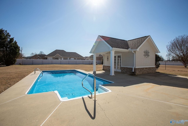 view of pool with an outdoor structure and a patio