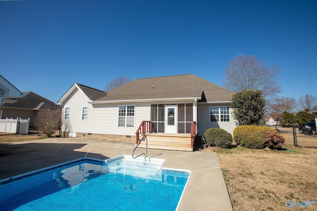 rear view of property with a sunroom, a patio area, and a lawn