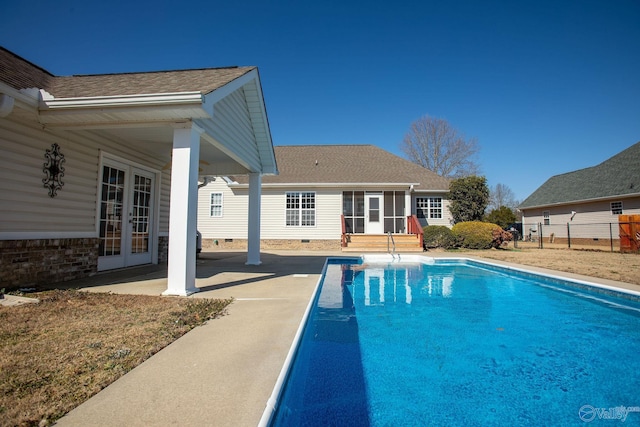 view of swimming pool featuring french doors and a patio