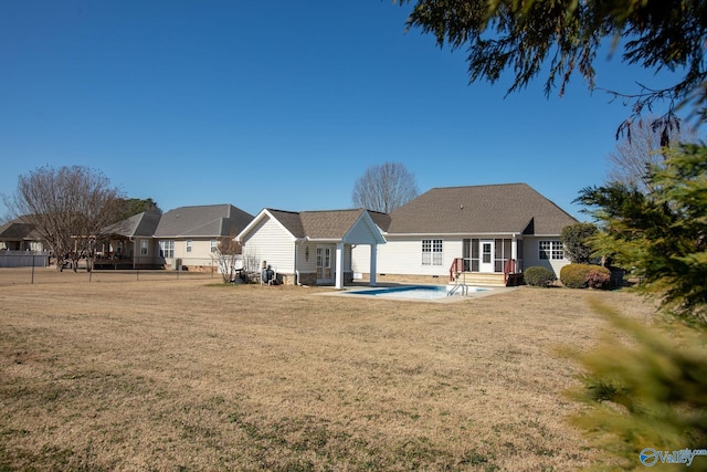 back of house with a fenced in pool, a yard, and a patio area