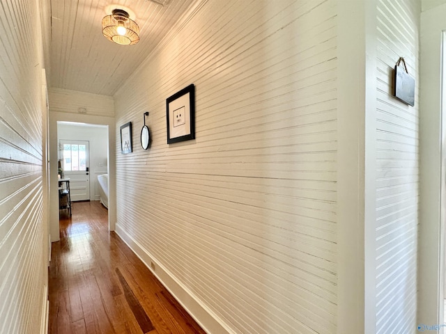 hall featuring dark wood-style floors and baseboards