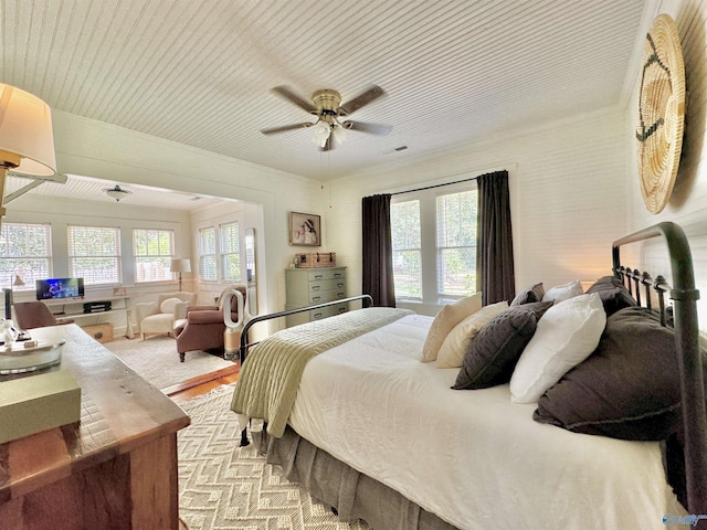 bedroom featuring multiple windows, visible vents, and a ceiling fan