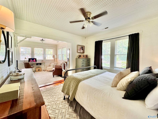 bedroom featuring multiple windows and ceiling fan