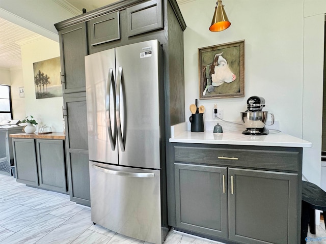 kitchen with stainless steel fridge, light tile patterned flooring, and gray cabinets