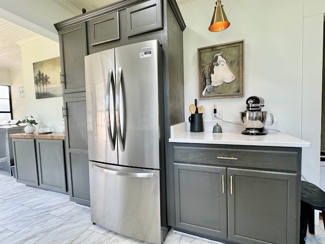 kitchen with freestanding refrigerator and light countertops