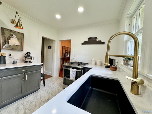 kitchen with marble finish floor, double oven range, crown molding, and a sink