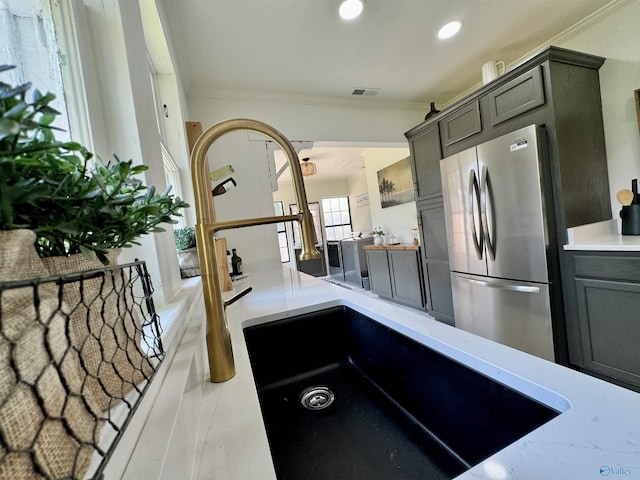 kitchen featuring ornamental molding, freestanding refrigerator, visible vents, and recessed lighting