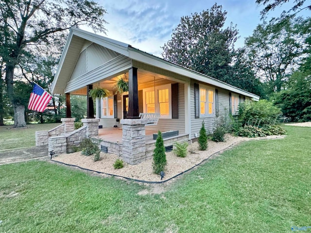 view of front of home with a front lawn and a porch