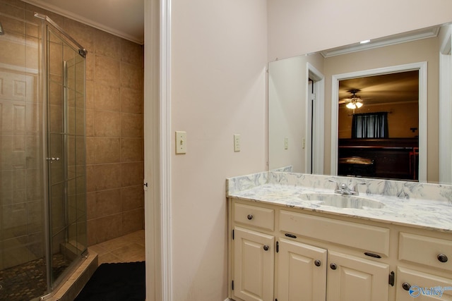 full bathroom with a stall shower, ornamental molding, and vanity