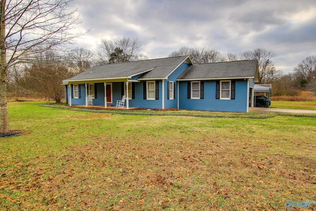ranch-style house featuring a carport, a front yard, a porch, and driveway