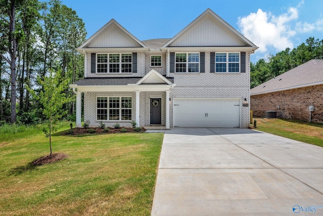 craftsman-style house featuring central air condition unit, a front yard, and a garage