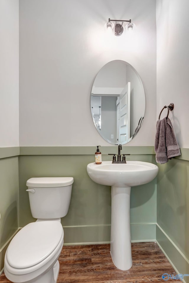 bathroom with toilet and wood-type flooring