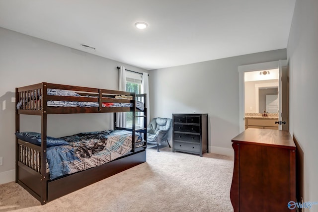 bedroom featuring carpet floors and ensuite bathroom