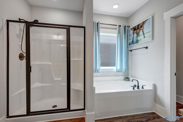 bathroom featuring separate shower and tub and hardwood / wood-style floors