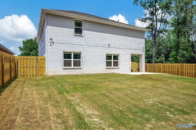 back of house with a lawn