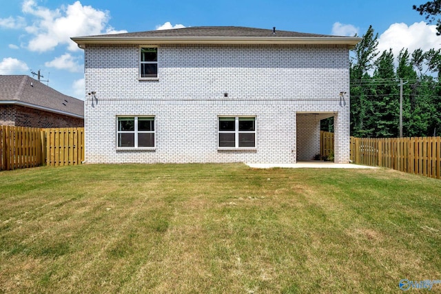 rear view of house with a lawn and a patio area