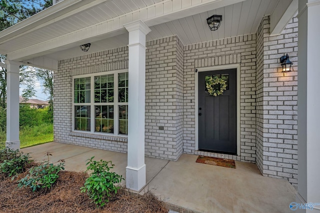 doorway to property featuring covered porch