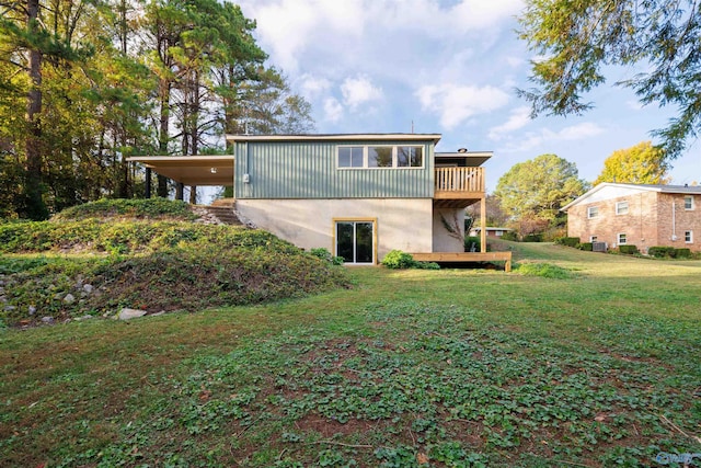 1002 Woodbine Rd, Madison, AL 35758 - back of property with a wooden deck, a carport, and a yard