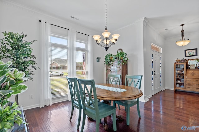 dining room featuring baseboards, ornamental molding, a chandelier, dark wood-style floors, and visible vents