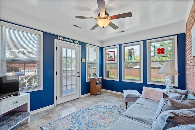 living room with a healthy amount of sunlight, ceiling fan, and visible vents