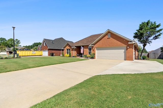 view of front of home with an attached garage, fence, brick siding, a front lawn, and driveway