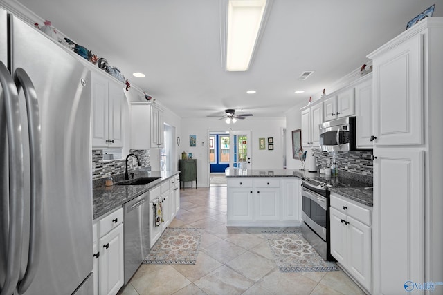 kitchen with a sink, recessed lighting, a peninsula, and stainless steel appliances