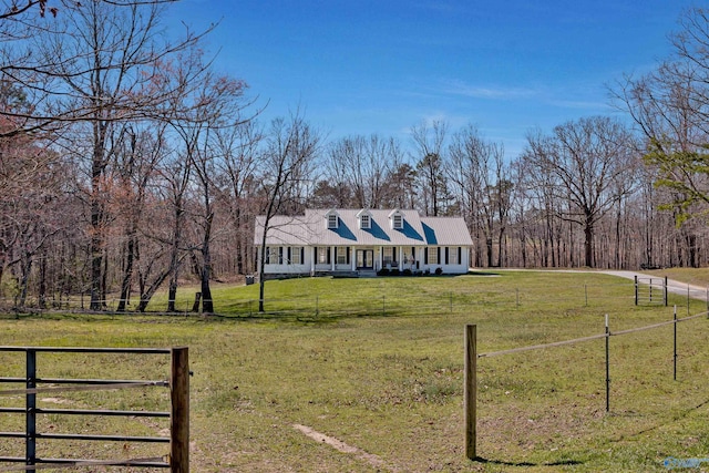 new england style home with fence and a front yard