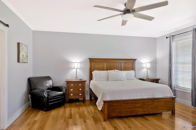 bedroom featuring light wood-style floors, ornamental molding, and baseboards
