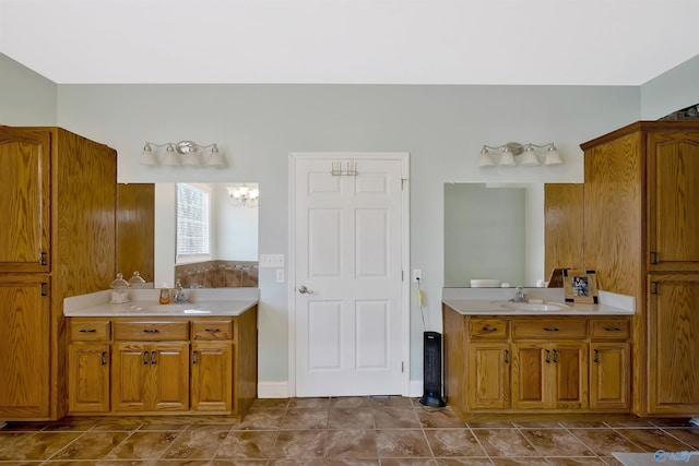 full bathroom with a notable chandelier, a garden tub, and vanity