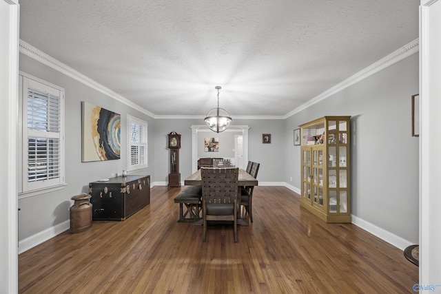 dining space with crown molding, dark hardwood / wood-style floors, a textured ceiling, and an inviting chandelier