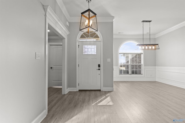 foyer entrance with hardwood / wood-style floors and ornamental molding