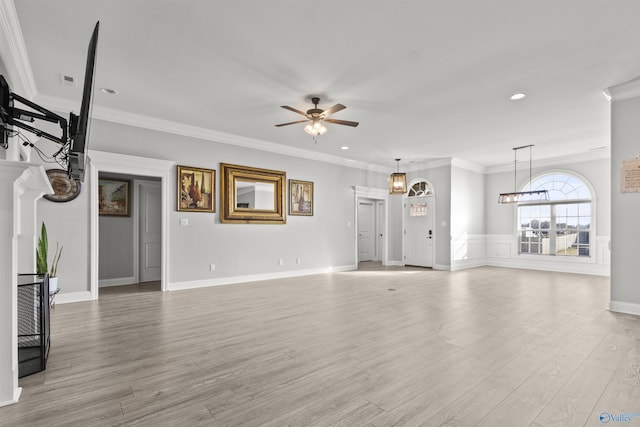 unfurnished living room with light wood-type flooring, ceiling fan, and ornamental molding