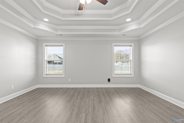 spare room featuring hardwood / wood-style flooring, plenty of natural light, and crown molding